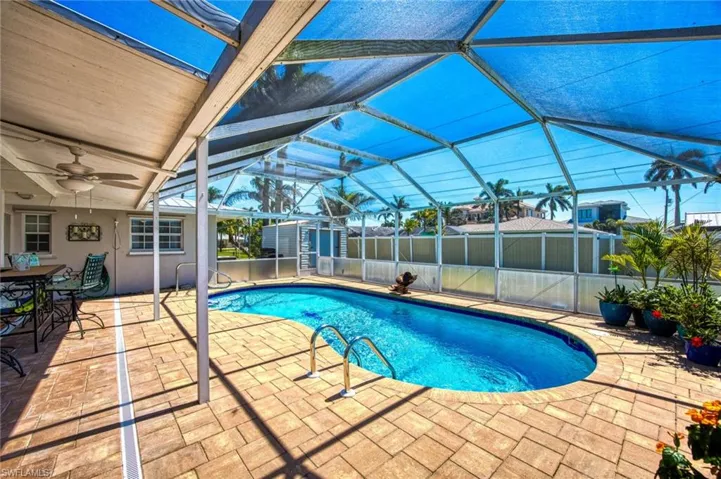 View of swimming pool with, fence, and a patio area