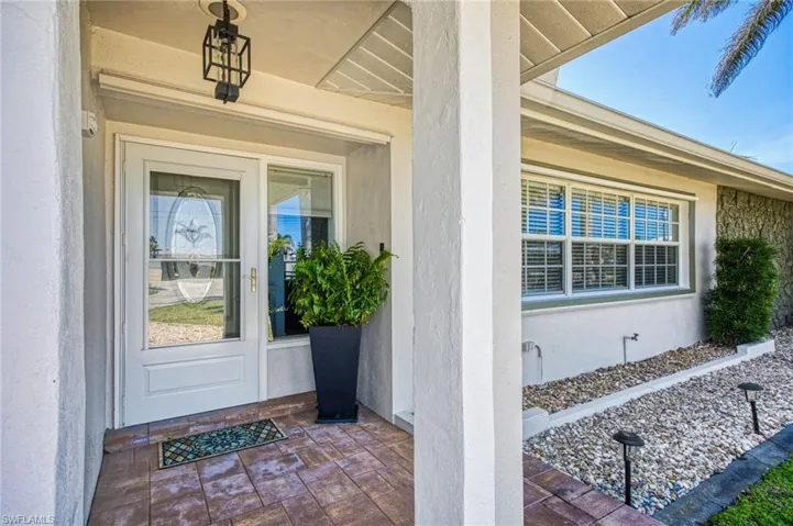 View of exterior entry with stucco siding