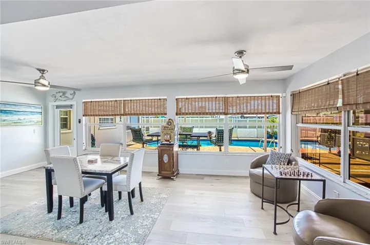 Sunroom featuring, wood finished floors, and ceiling fans