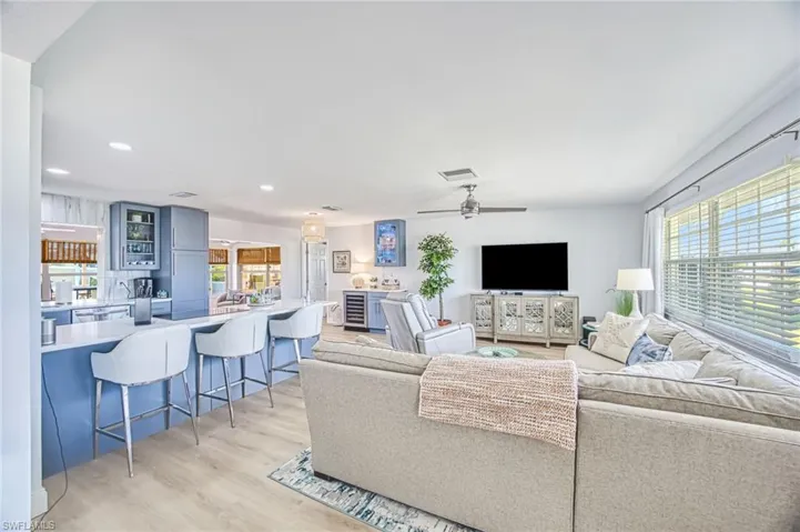 Living room with open concept, recessed lighting, and light wood-type flooring