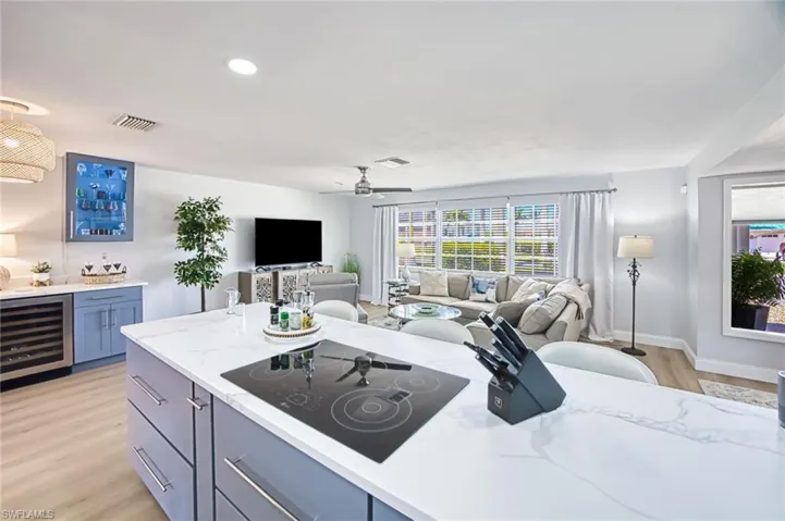 Kitchen featuring wine cooler bar, electric cooktop, and light wood-type flooring