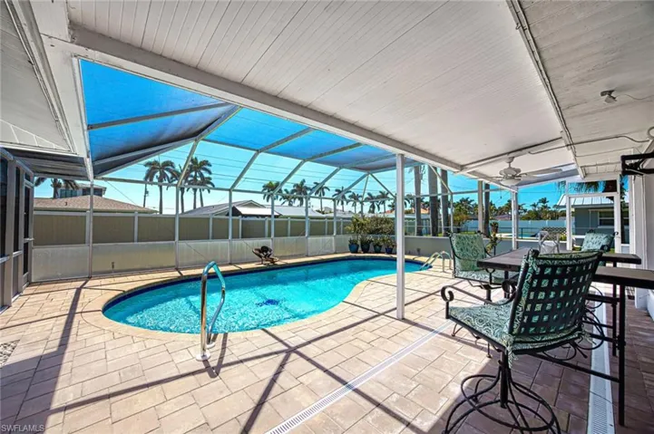View of swimming pool with a fenced in pool, a patio, and a lanai