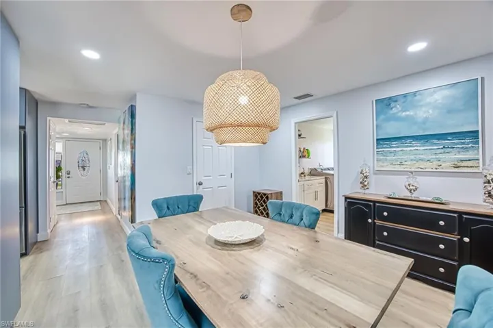 Dining room with recessed lighting, and light wood-type flooring