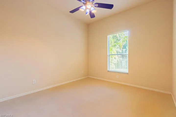 Bedroom featuring carpet and an upgraded ceiling fan.