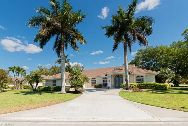 Mediterranean / Spanish-style home featuring driveway, a newer tiled roof located on 1/4-acre corner lot.