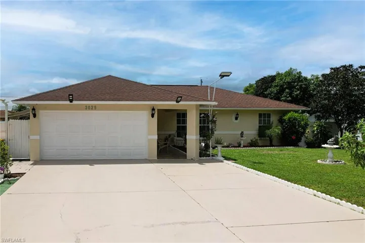 Single story home with a front lawn and a garage