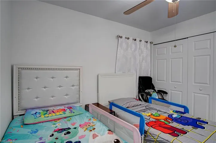 Bedroom featuring ceiling fan and a closet