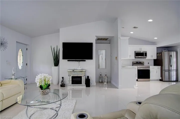 Tiled living room with lofted ceiling