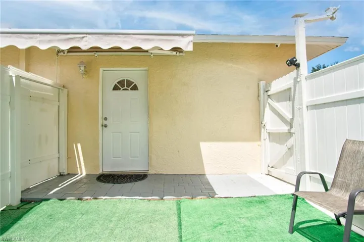 View of exterior entry featuring a yard