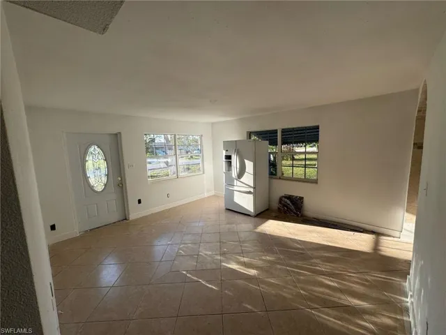 Tiled entryway with baseboards
