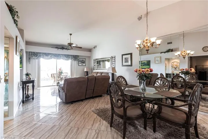 Dining room featuring ceiling fan and lofted ceiling