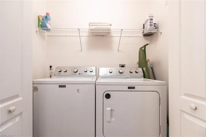 Clothes washing area featuring washer and clothes dryer