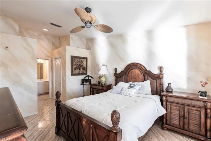 Bedroom with ensuite bath and ceiling fan