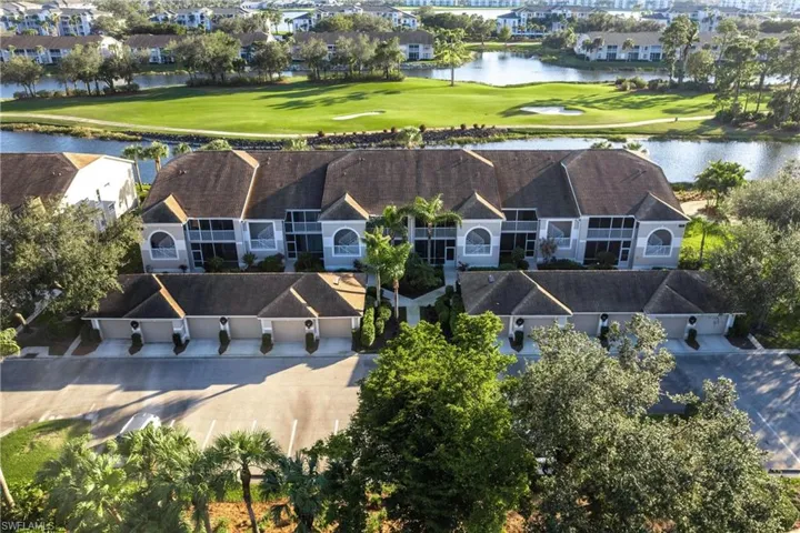 Birds eye view of property with a water view