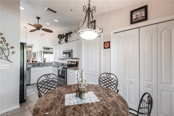 Dining area featuring sink, ceiling fan, and light tile patterned flooring