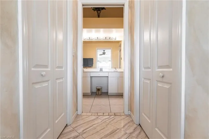 Hall with light tile patterned flooring