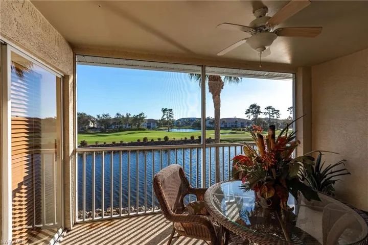 Sunroom / solarium featuring a water view and ceiling fan