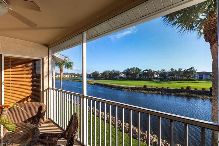Sunroom featuring a water view and ceiling fan