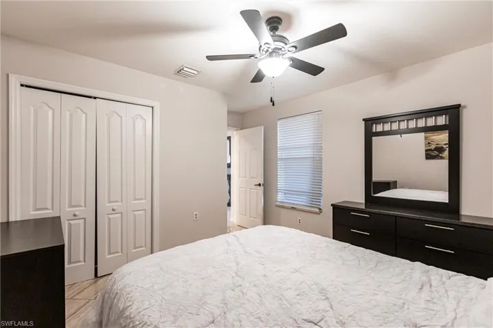 Bedroom featuring ceiling fan and a closet