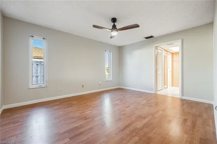 Unfurnished room featuring ceiling fan, a textured ceiling, and light wood-type flooring