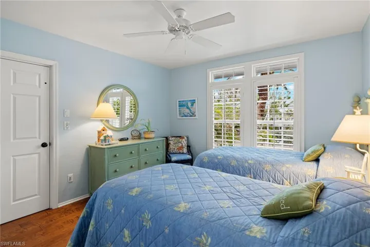 Bedroom featuring dark hardwood / wood-style floors and ceiling fan