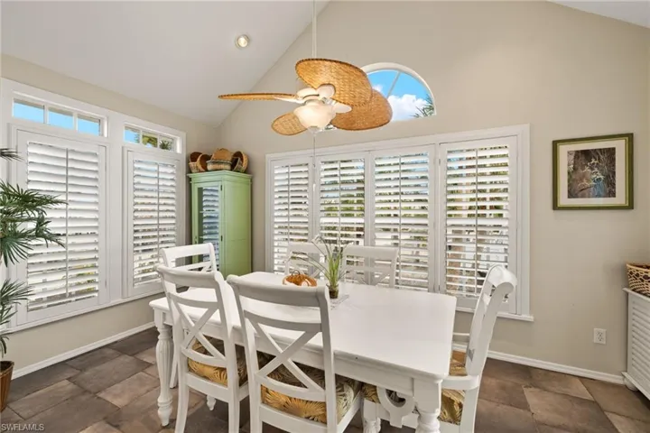 Dining space featuring high vaulted ceiling and plenty of natural light