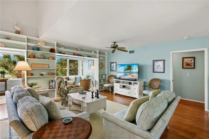 Living room featuring ceiling fan and dark hardwood / wood-style floors