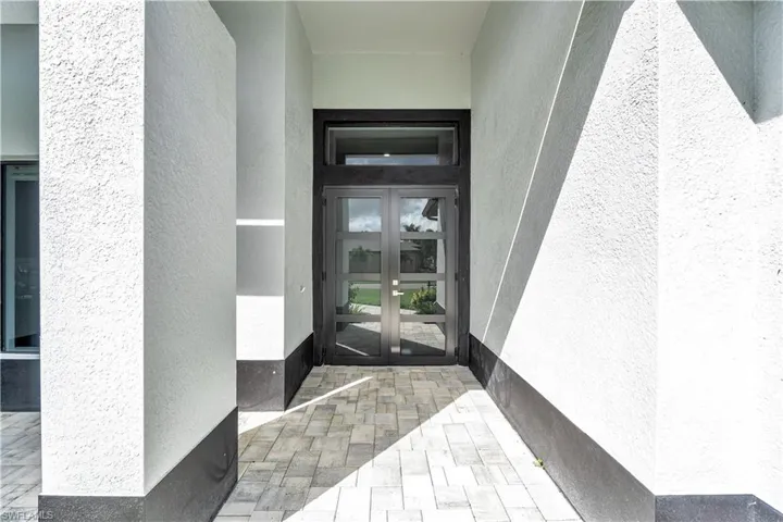 Entrance to property featuring french doors and stucco siding