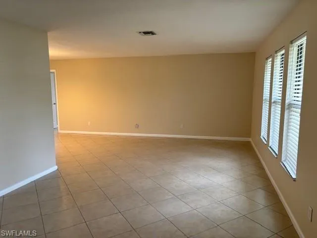 Tiled empty room with a wealth of natural light