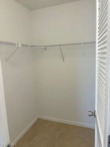 Walk in closet featuring light tile patterned floors