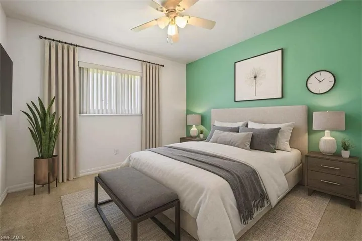 Bedroom featuring light colored carpet and a ceiling fan
