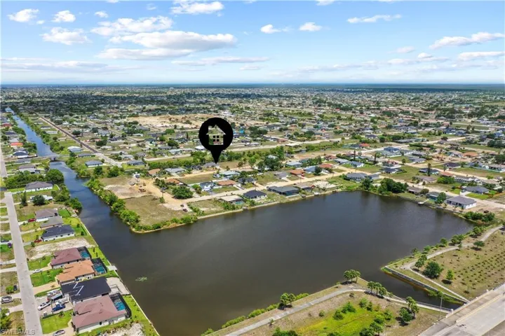 Aerial overview of property's location with a nearby body of water and nearby suburban area
