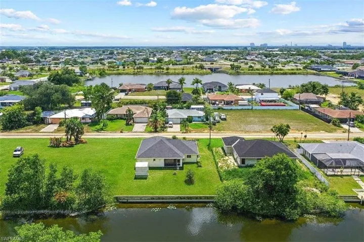 Aerial perspective of suburban area with a nearby body of water