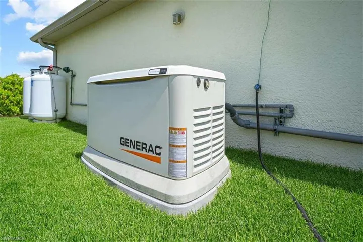 Exterior view of stucco siding and a power unit