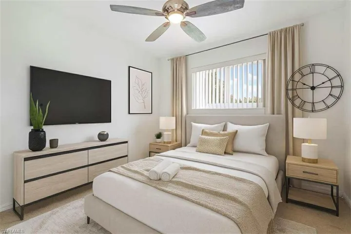 Bedroom featuring light carpet and a ceiling fan