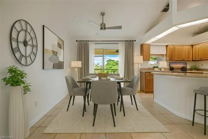 Dining area with light tile patterned flooring and ceiling fan