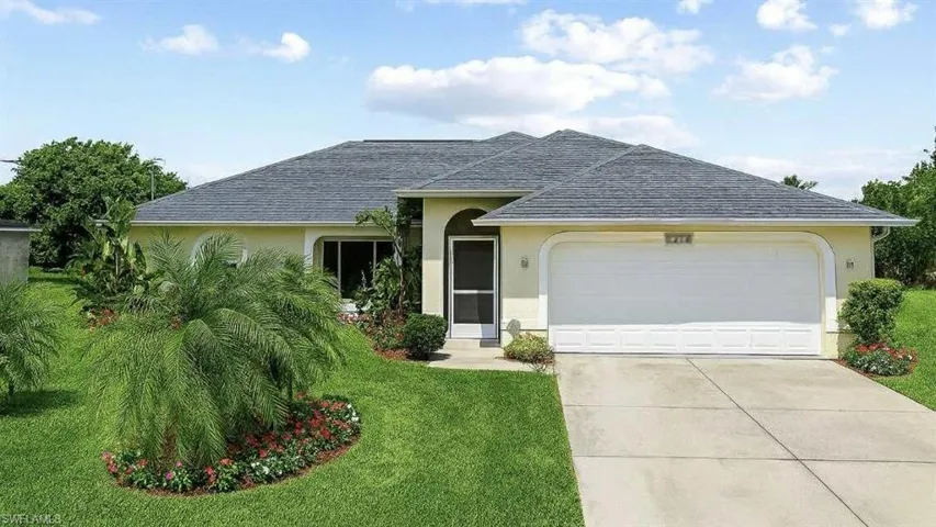 Single story home with stucco siding, a garage, and roof with shingles