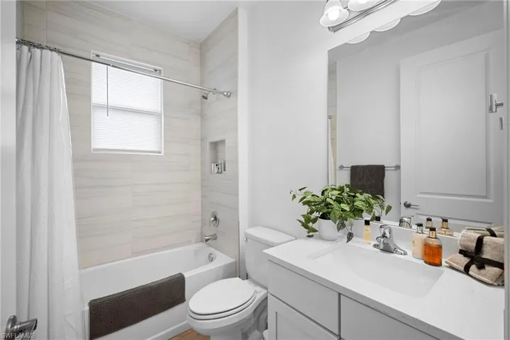 Full bath featuring vanity and shower / bath combo with shower curtain
