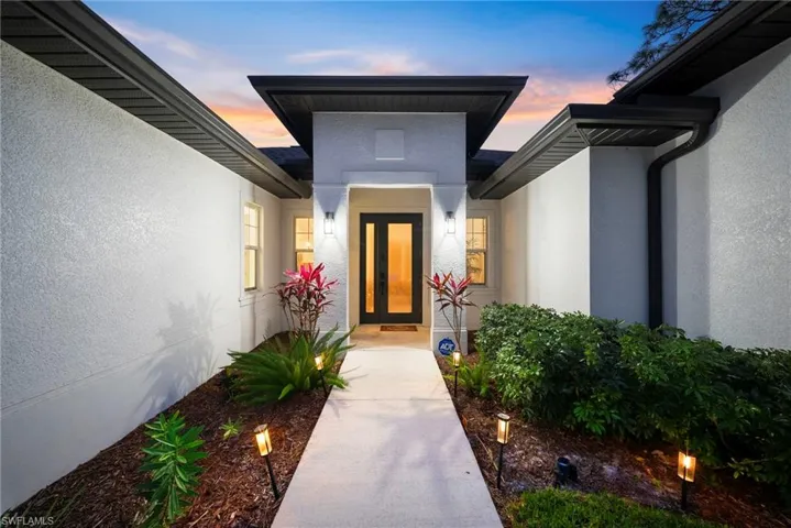 View of exterior entry featuring stucco siding