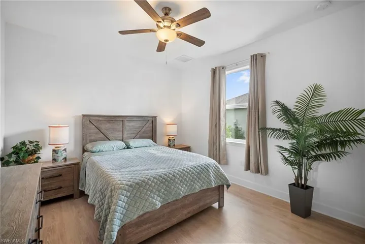Bedroom with light wood finished floors and a ceiling fan