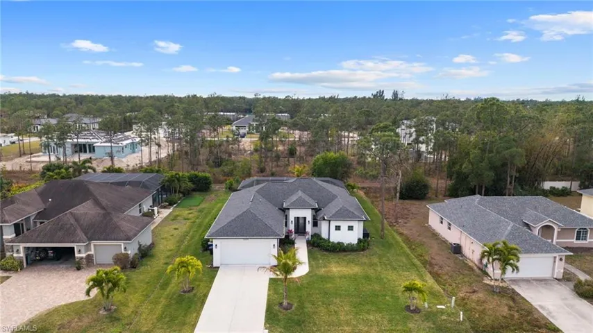 Aerial perspective of suburban area featuring a tree filled landscape