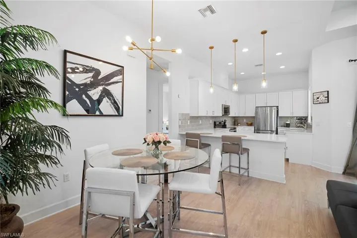 Dining room featuring light wood finished floors and suspended lighting