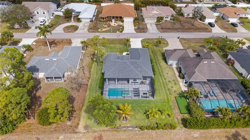 Aerial perspective of suburban area with a pool area