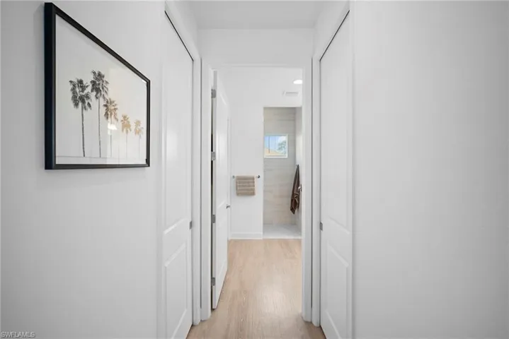 Corridor featuring light wood finished floors