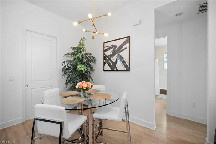 Dining space featuring suspended lighting and light wood-style flooring