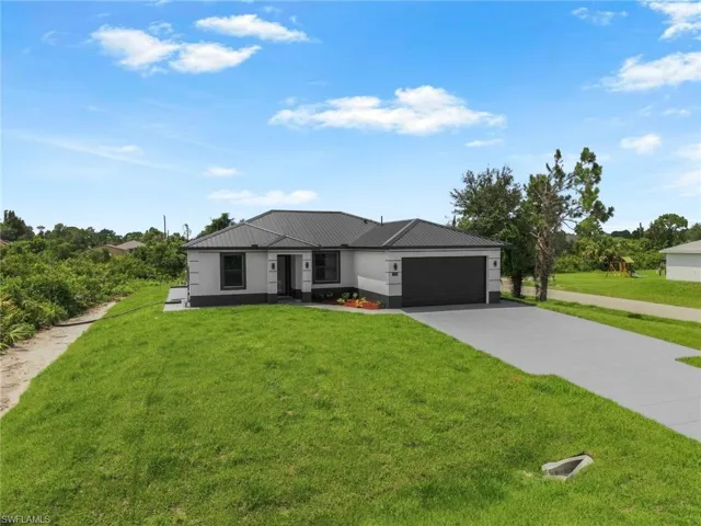 Contemporary single-story exterior with a metal roof and an attached two-car garage