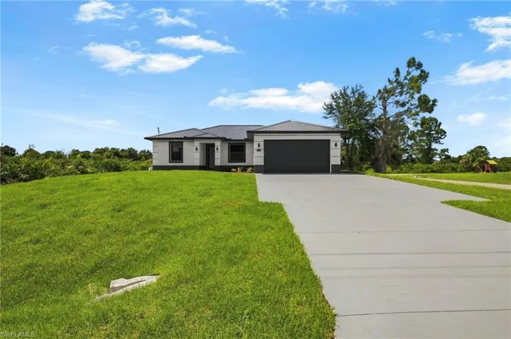 Contemporary single-story residence with a metal roof and an attached garage