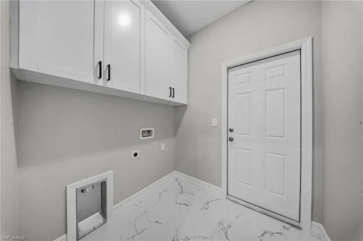 White shaker-style cabinetry with matte black hardware