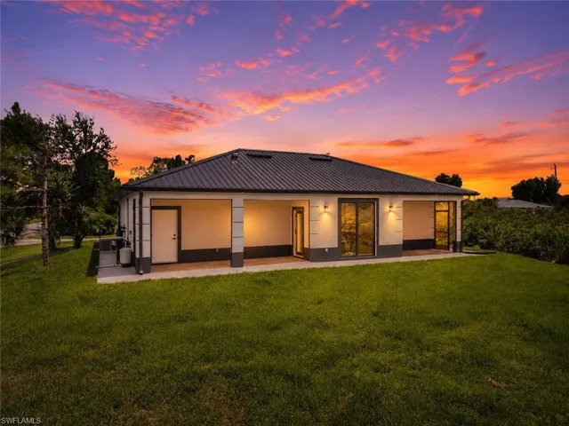 Contemporary single-story residence with a metal roof and an expansive rear patio