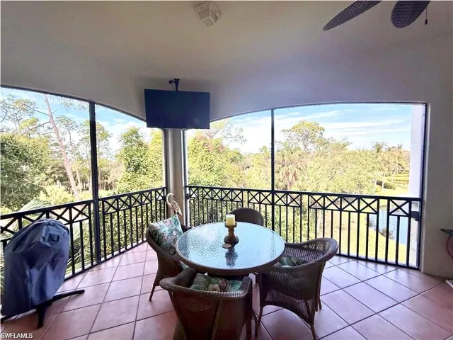 Balcony with grilling area, outdoor dining space, and a ceiling fan